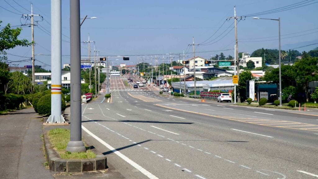 A long stretch of Il-ju Road runs through Namwon with shops, signals, and a painted cycling lane.