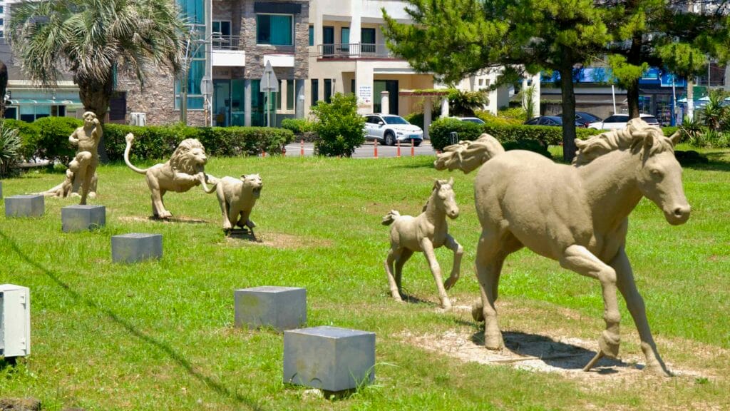 Animal sculptures stand on a grassy verge near Pyoseon’s town center.