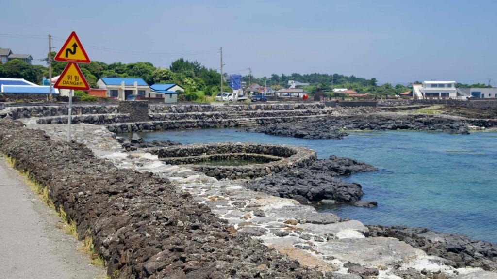 Circular stone pools and lava seawalls line the Onpyeong coast.