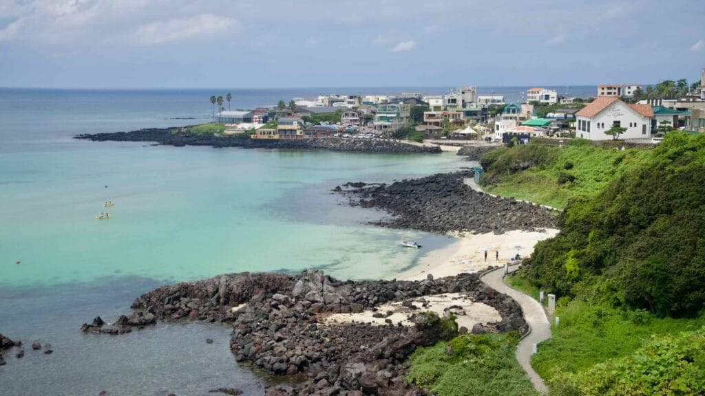 Offshore wind turbines rise from calm waters off Jeju’s northwest coast.