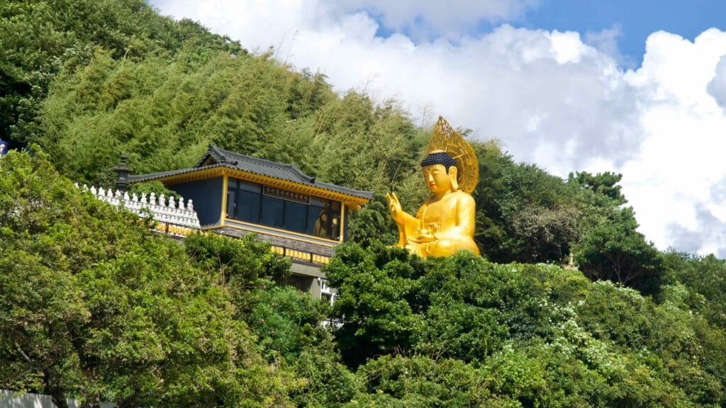 Golden Buddha statue on Sanbangsan’s forested slope.
