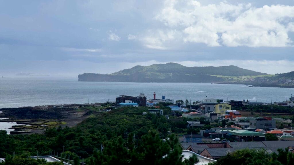 A wide view from Sanbangsan shows Songak Mountain and Jeju’s south coast.
