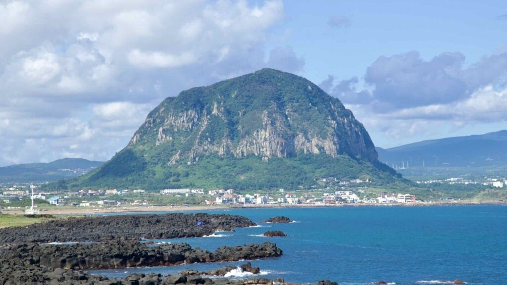 Close profile of Sanbangsan above seaside homes.