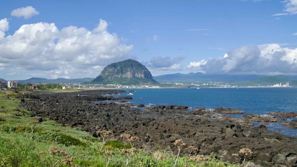 Sanbangsan across Sagye Bay with basalt shoreline.