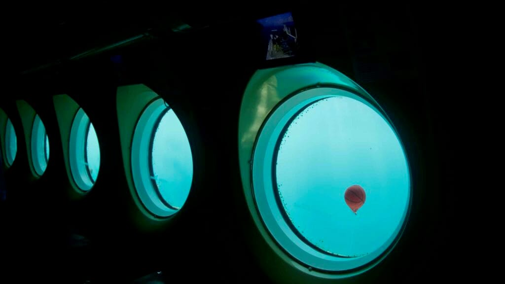 A forested headland and layered cliffs of Munseom project into open sea.