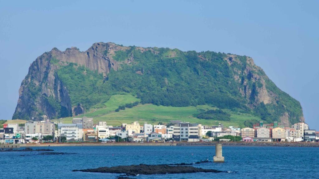 A closer bay view frames Sunrise Peak above the town of Seongsan-eup.