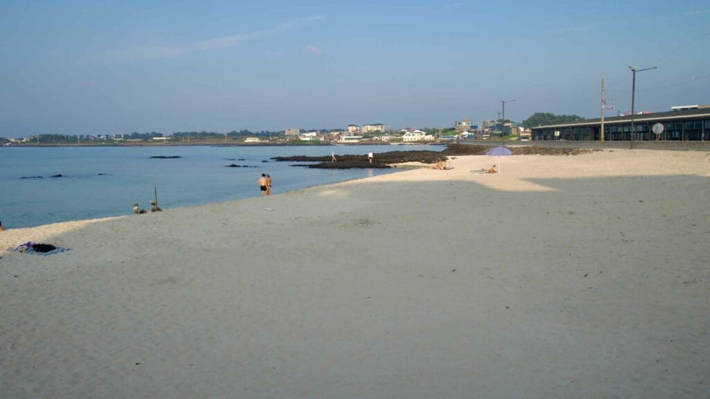 Early visitors relax and swim along the soft white sands of Sehwa Beach.