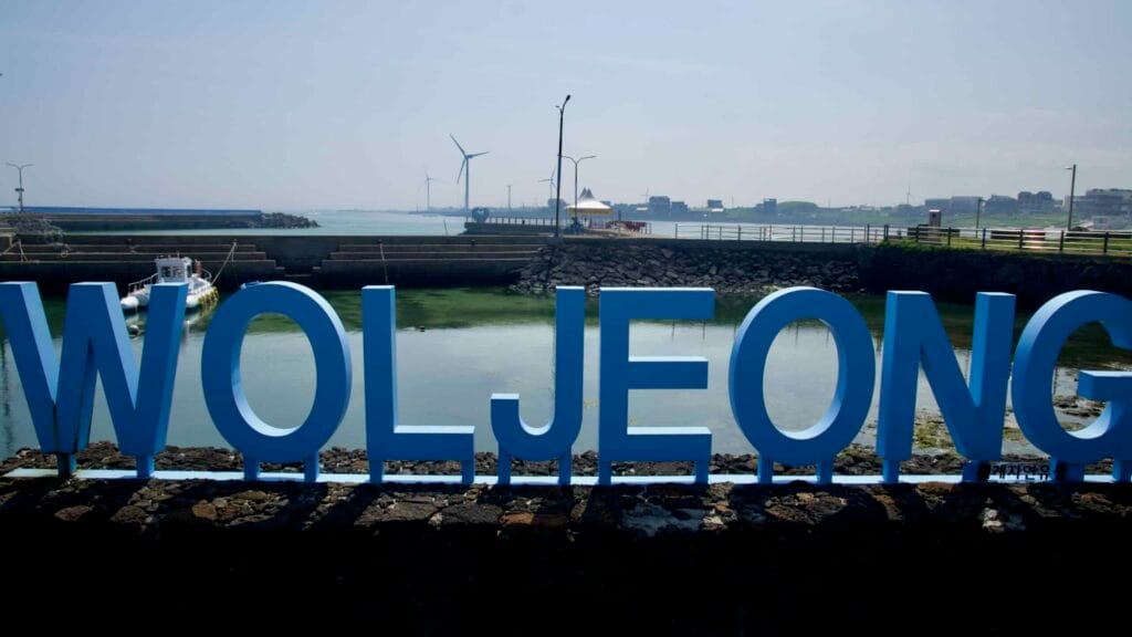 Landmark letters overlook Woljeongri’s harbor basin and breakwaters.