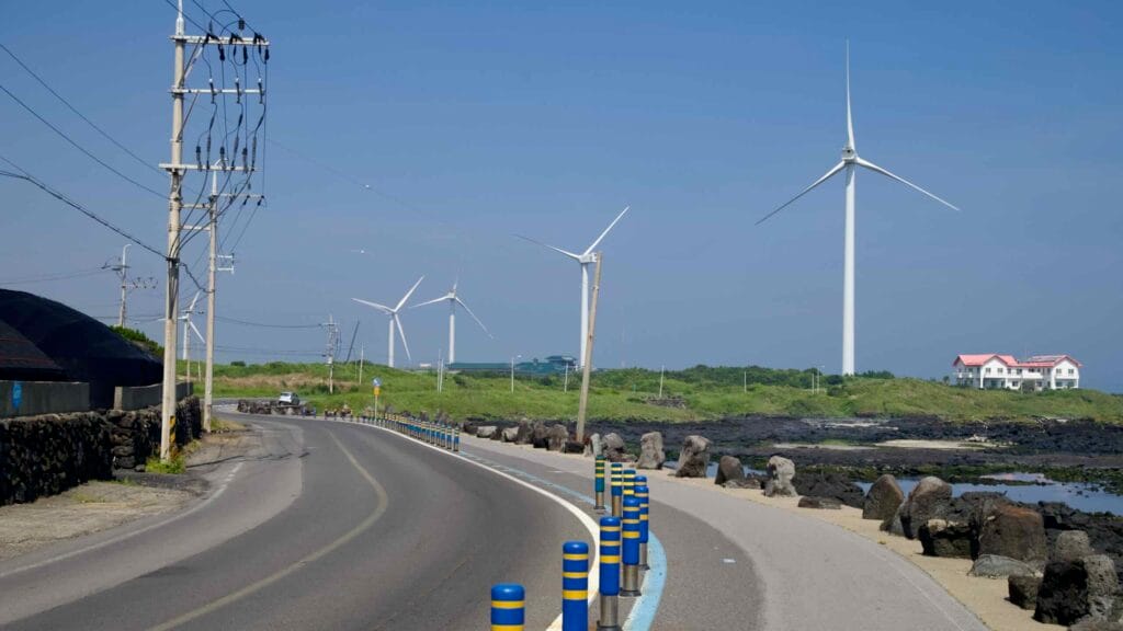 A cycling lane runs below wind turbines on Jeju’s northeast coast.