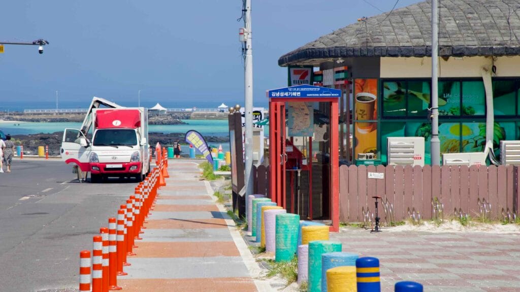 Red booth marks the Gimnyeong Seongsegi Beach Certification Center.