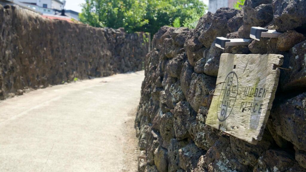 A renovated lava-stone house stands along the lanes of Gimnyeong’s Metal Craft Mural Village.