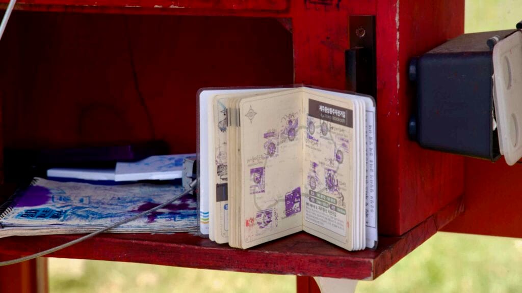 An open cyclist passport sits at the Hamdeok Seoubong certification station.