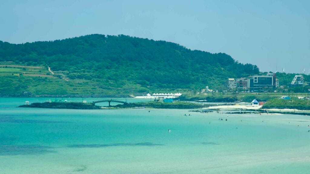 A view over Hamdeok Seoubong Beach shows a shallow emerald lagoon.