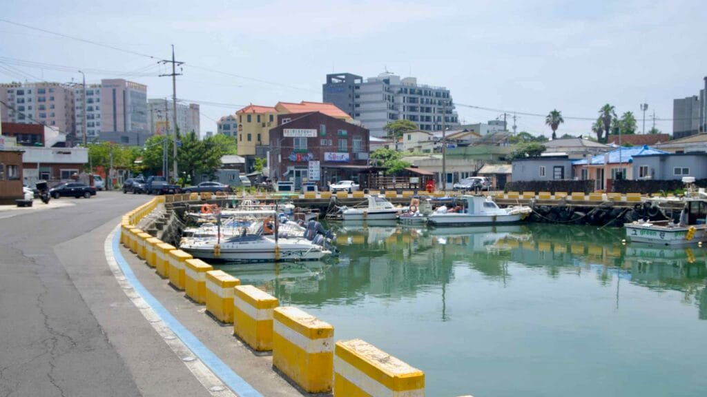 Small fishing boats moor in the sheltered inner basin at Jeongju Port.