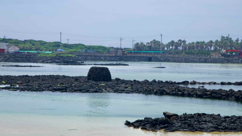 Low stone fish weirs ring the tidal flats near Shinheung Beach at low tide.