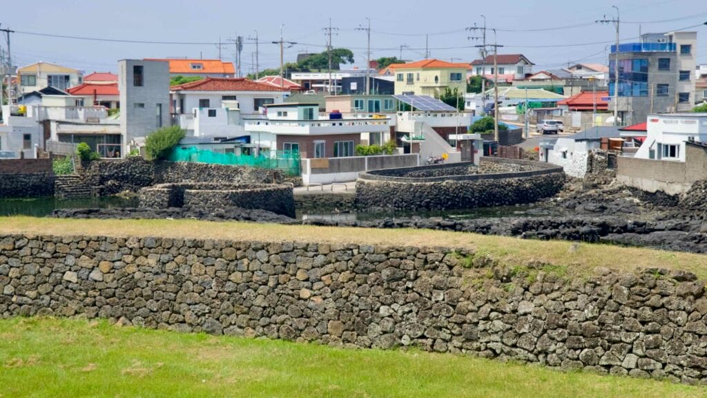 Basalt embankments enclose spring-fed pools near Jocheon’s homes.
