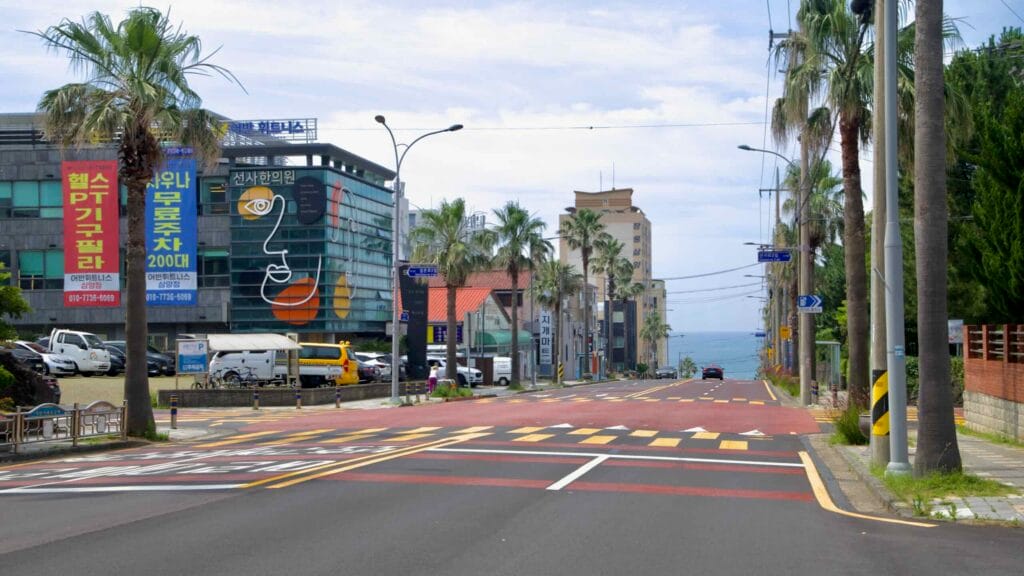 Palms line a boulevard descending toward the sea in Samyang.