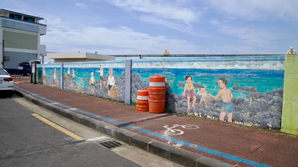 A seawall mural brightens the bike lane near Samyang Beach.