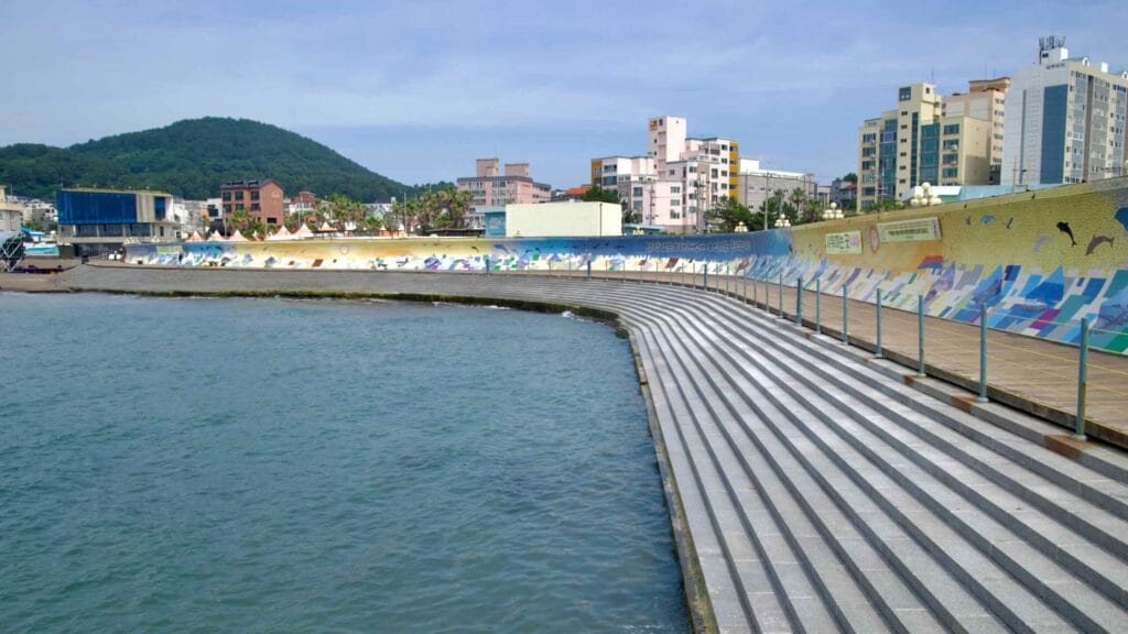 Curving steps and a mosaic seawall wrap Samyang’s waterfront promenade.