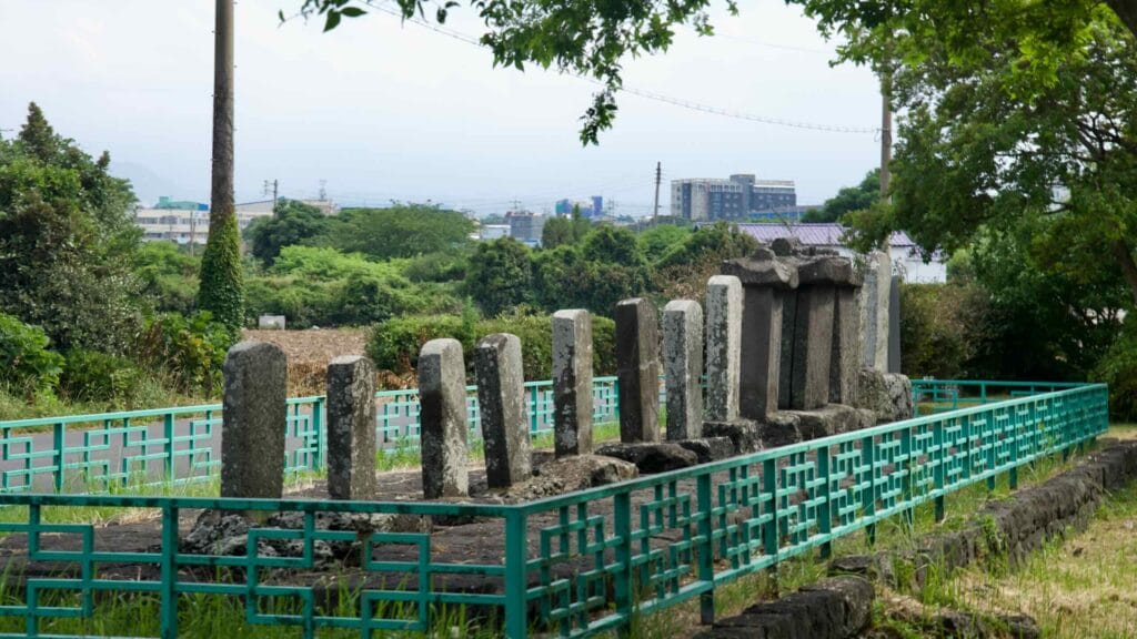 Stone steles line Hwabuk’s stele street beneath Byeoldo Peak.
