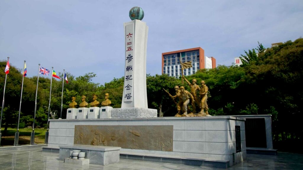 The Korean War memorial features a tall inscribed pillar, bronze reliefs.