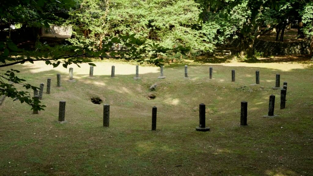 An elevated view looks across the circular array of marker posts around the hollow.