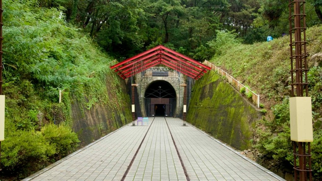 The Omija Theme Tunnel stone arch and red canopy mark the start of the themed walkway.