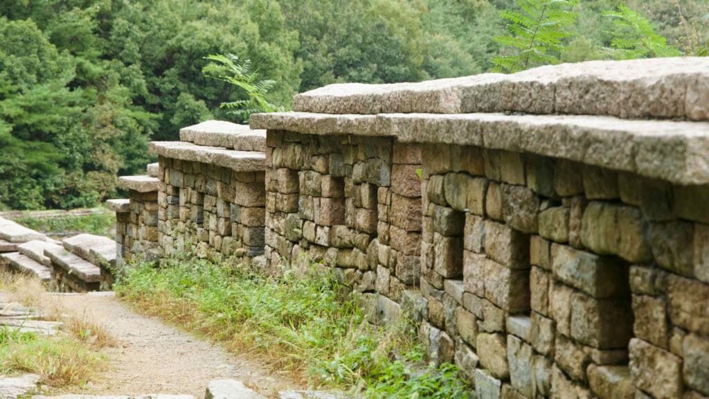 Embrasures cut through stacked granite on the Gomo Fortress wall.