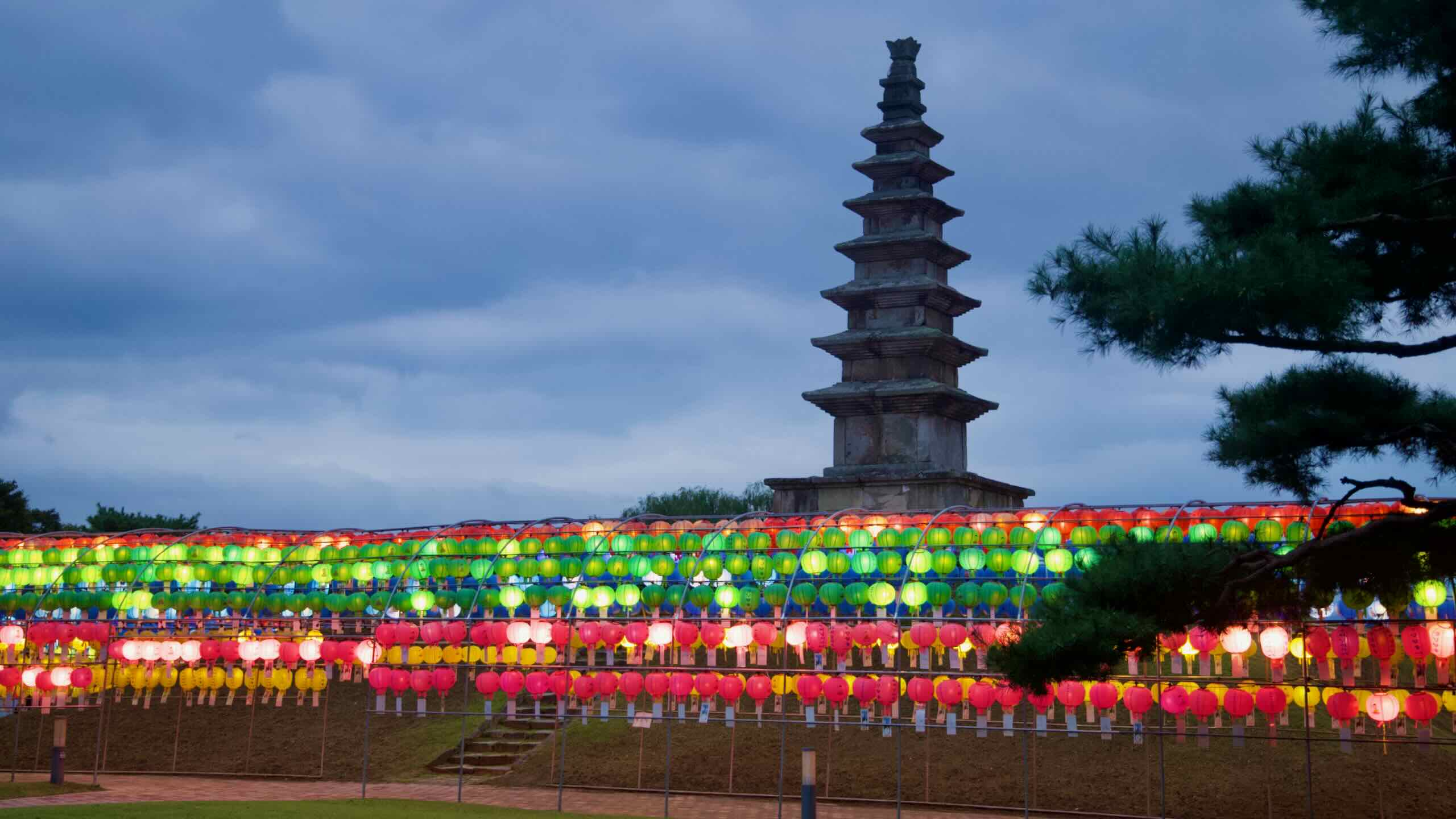 Jungang Tower rises above tiers of colorful lanterns in Jungangtap Park.