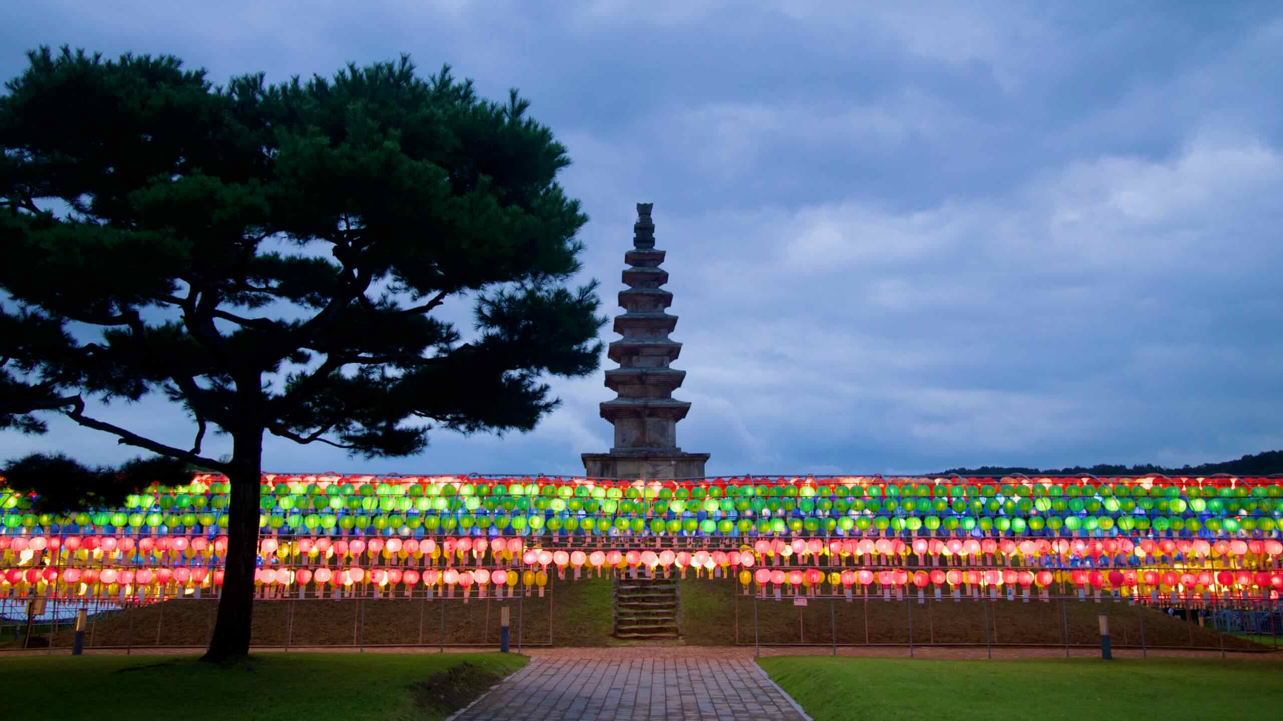 A straight path leads to Jungang Tower as rows of lanterns light the lawn at Jungangtap Park.