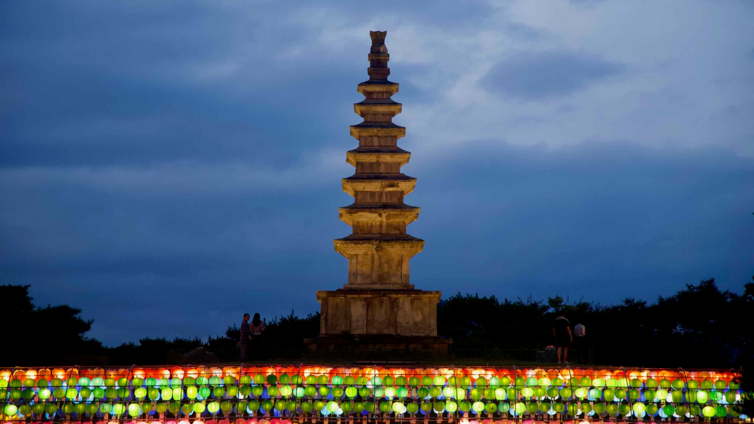 Chungju’s seven-story Central Tower rises above lanterns in Jungangtap Park as people gather.