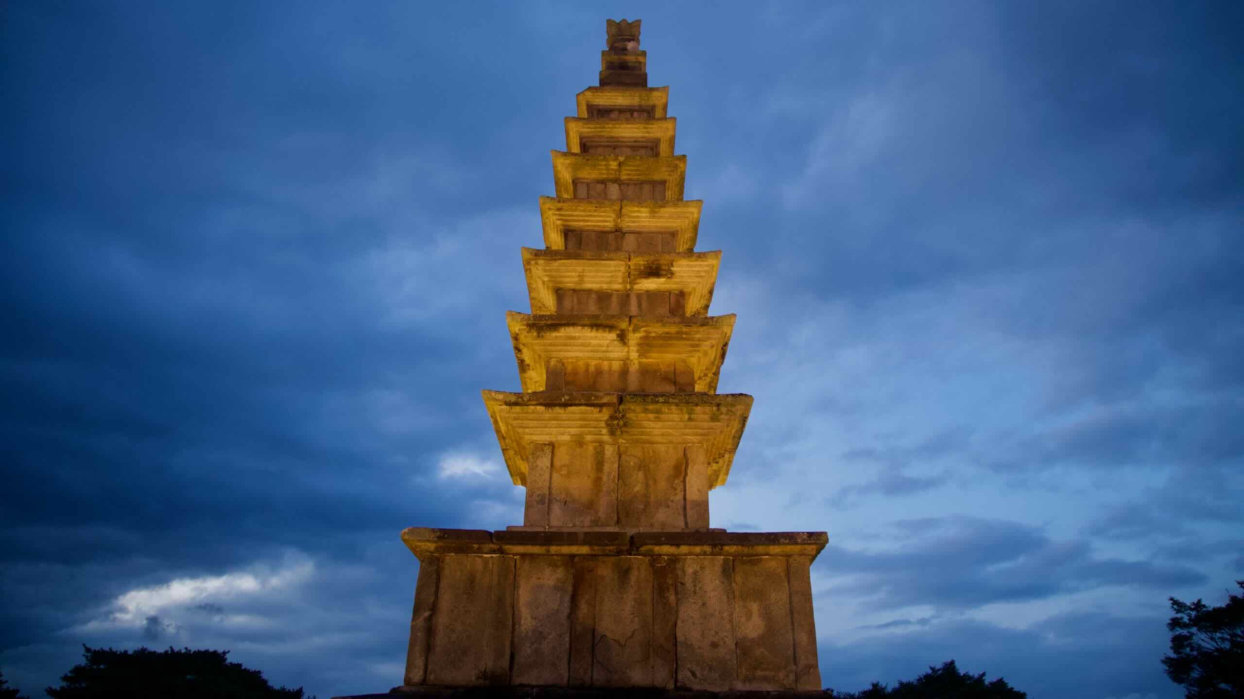 The seven-story Central Tower glows against a deep blue sky in Jungangtap Park.