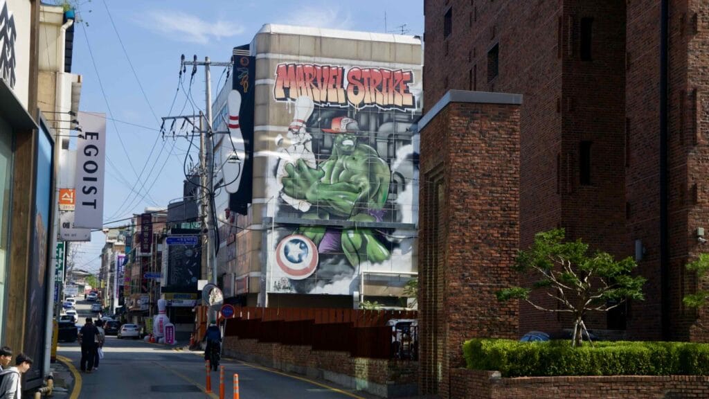 A comic-style Hulk mural brightens a narrow downtown alley of small shops in Chuncheon.