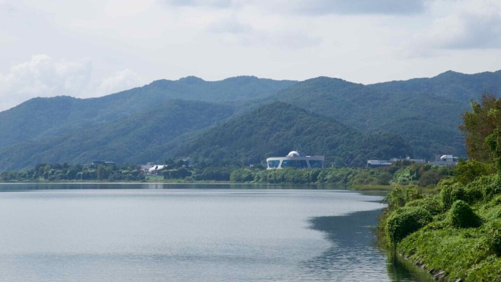 Distinctive domed building on the far shore beyond the quiet water of Uiam Lake.
