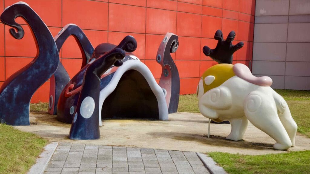 An octopus-themed tunnel and crouching character sculpture greet visitors outside the Animation Museum.