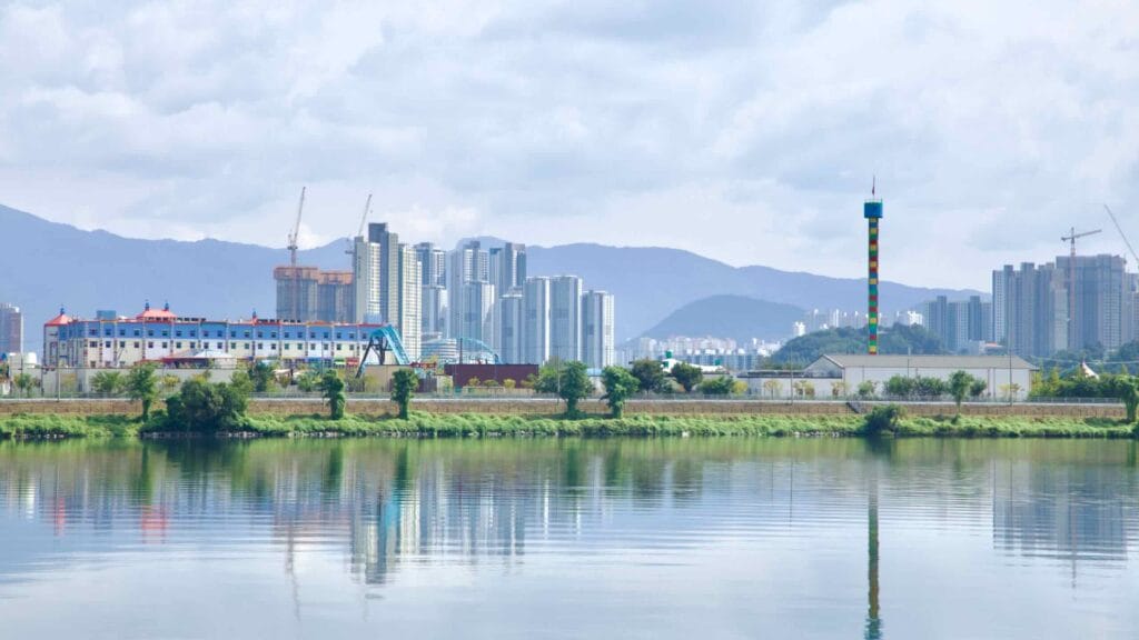 Uiam Lake reflects Chuncheon’s skyline with Legoland Korea rides and an observation tower across the water.