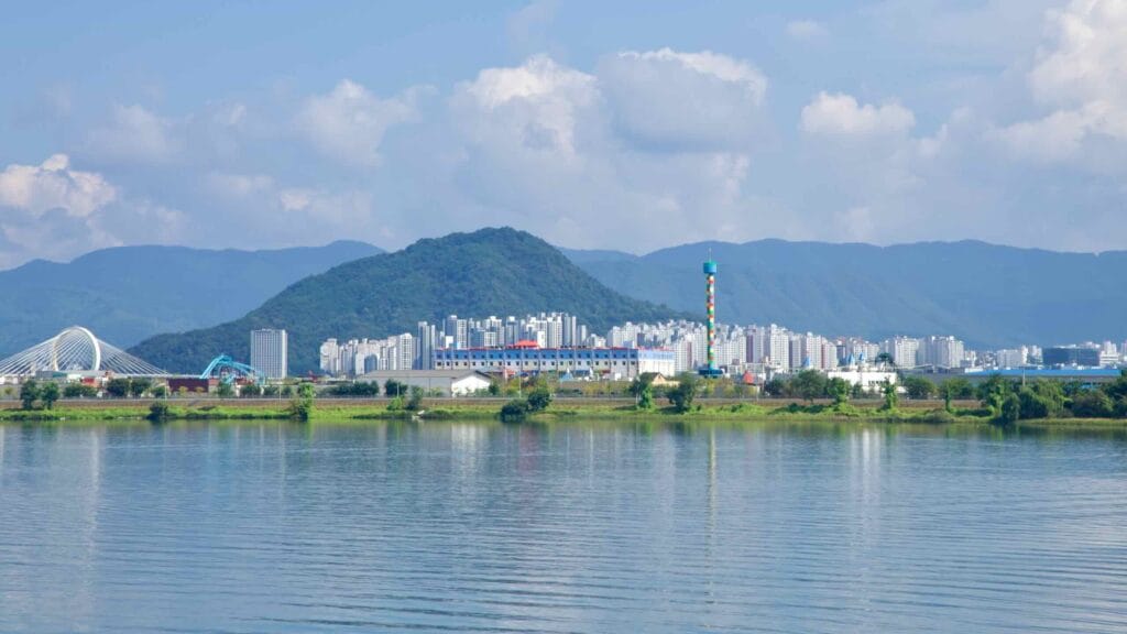 Uiam Lake stretches toward Hajungdo, Legoland’s tower, and the white arch of Chuncheon Grand Bridge.