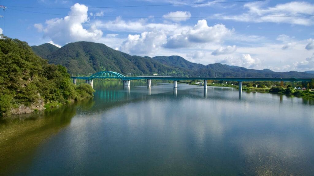 The green arch of the Gyeongchun Line bridge spans the Bukhangang near Gapyeong.