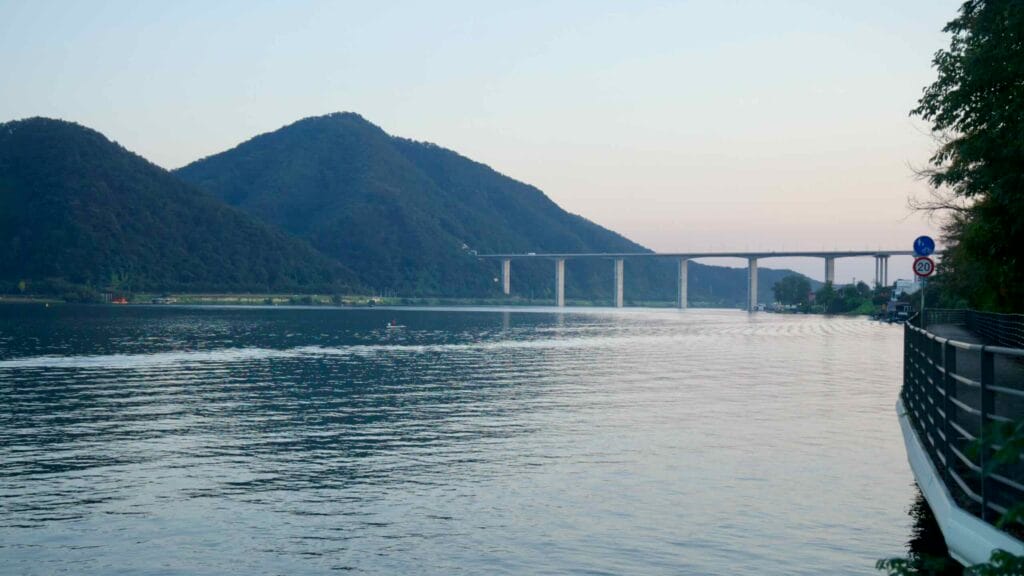 Ripples lead toward a high viaduct on the North Han River at Namyangju.