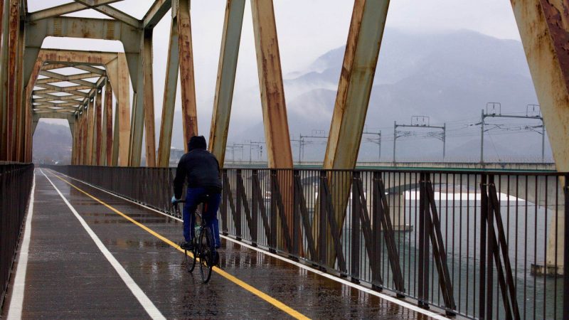 A picture of a bike rider on the Bukhangang Bridge outside of Seoul.